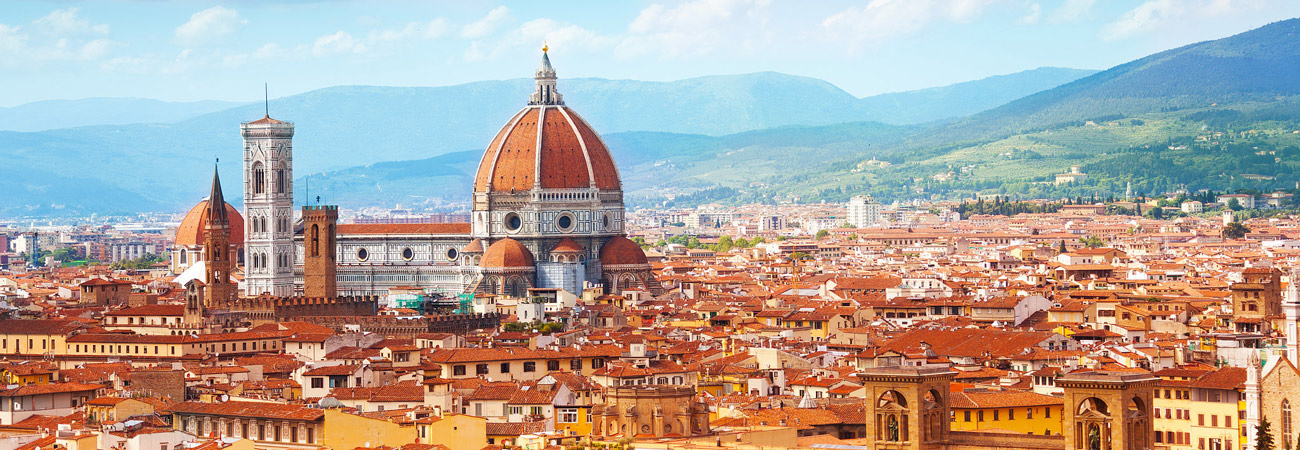 rooftop view of the City of Florence, with flat red roofs and the Duomo