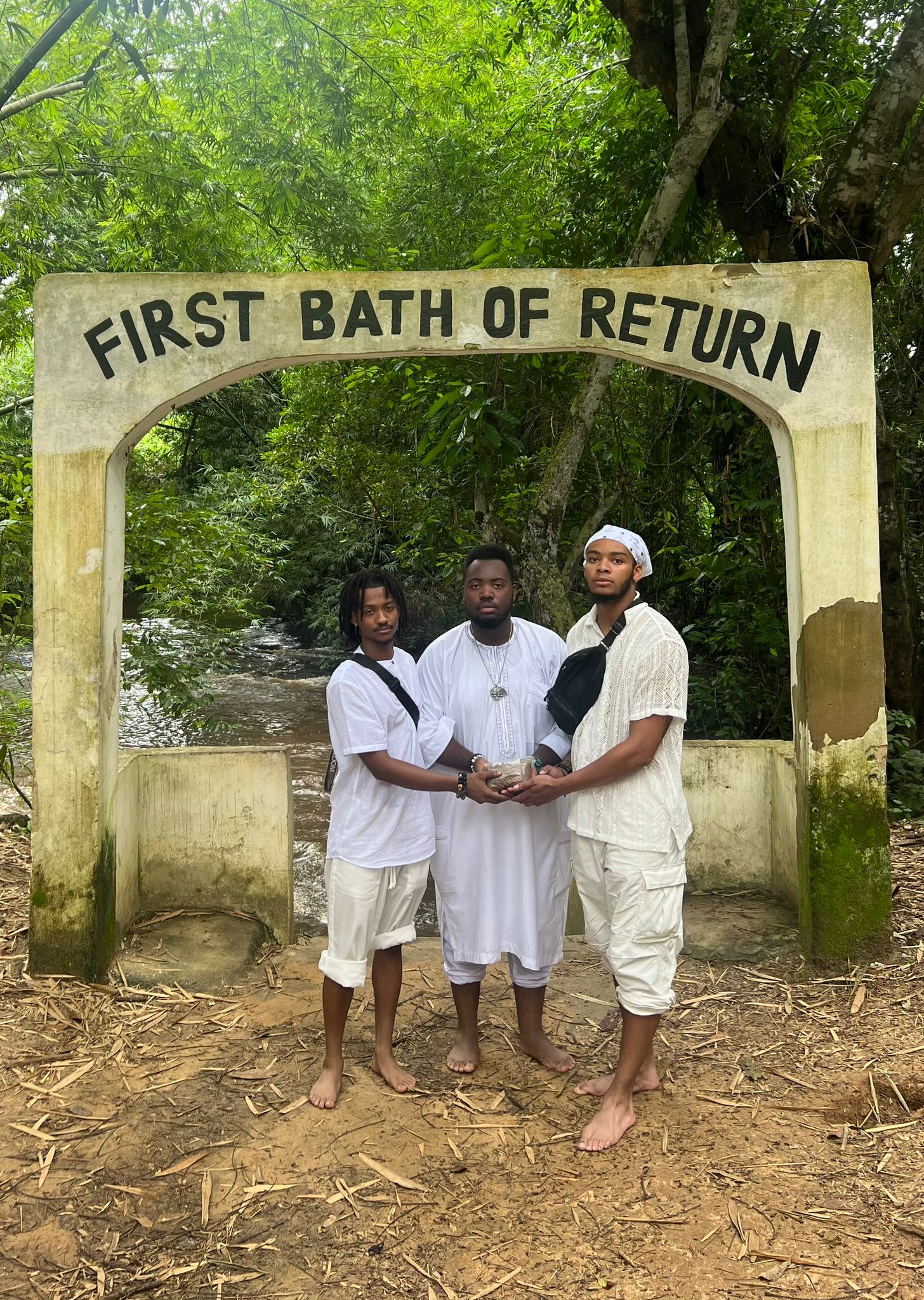 three students by a historic river in Ghana