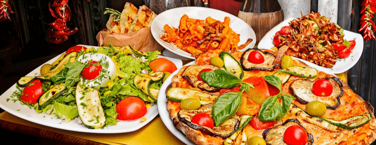 tableful of pizza and pasta